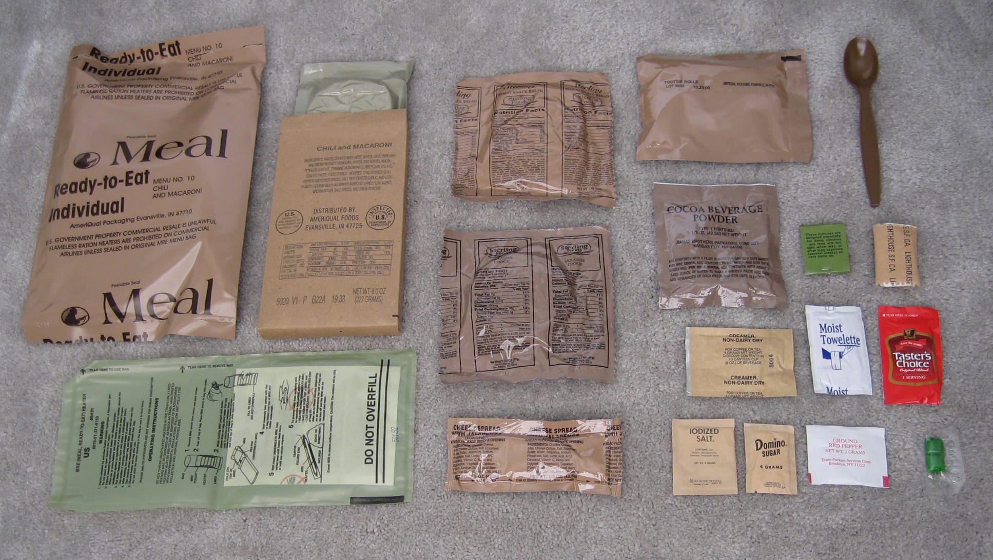 An MRE with the contents unpackaged on display to showcase the foods included.