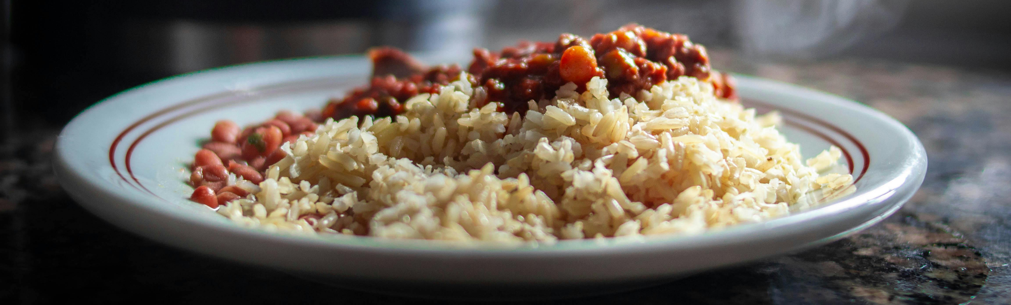 Steaming rice and beans on a plate.
