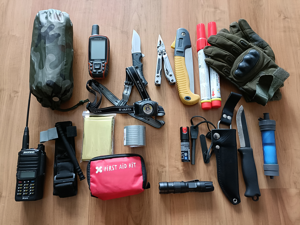 A radio, GPS, pocketknife, multi tool, folding saw, first aid kit, flashlight, water filter, and more.