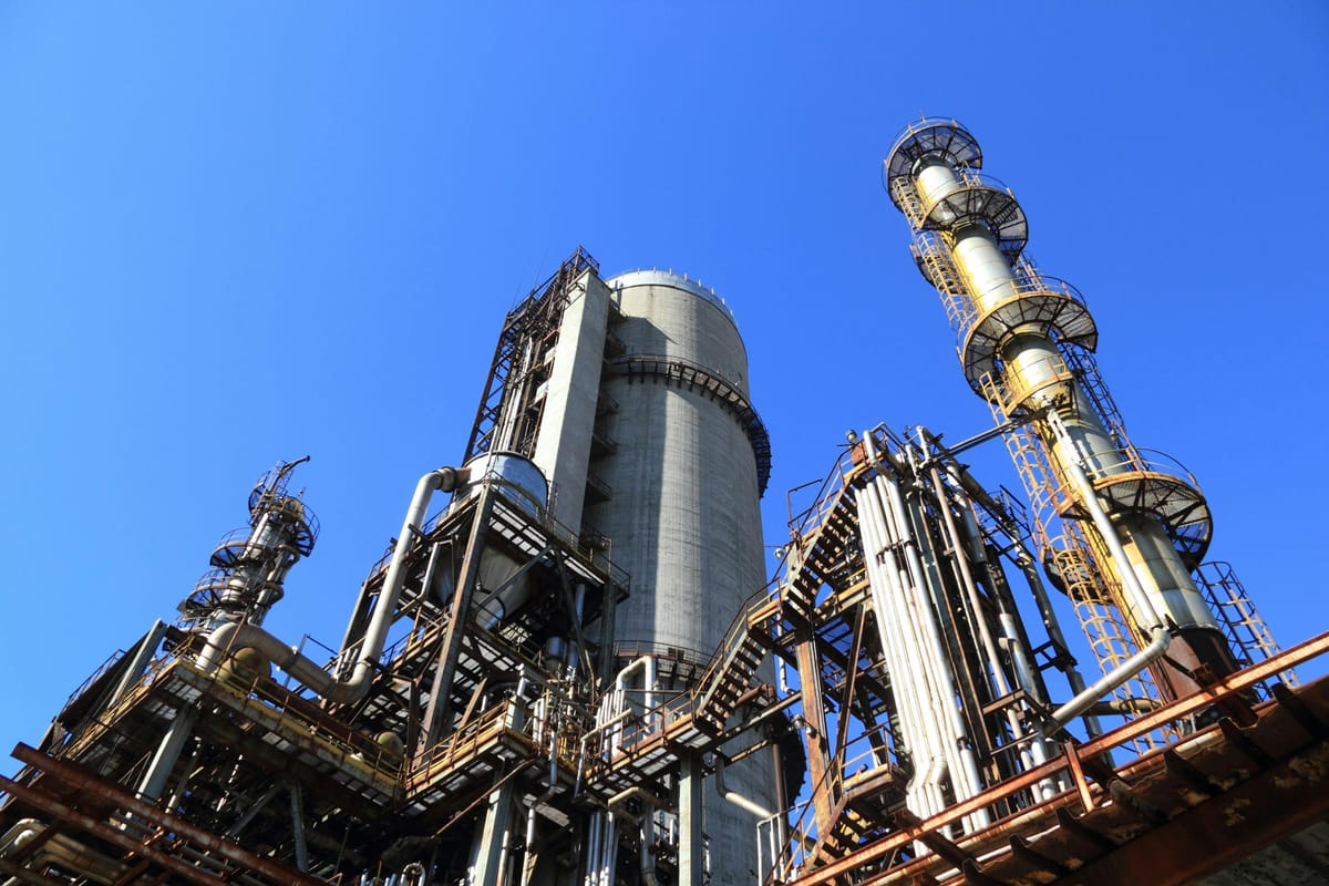 View of industrial refinery with clear blue skies behind it